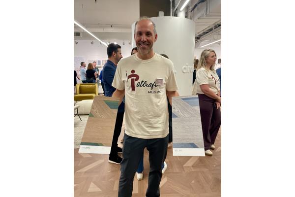 Patcraft's Kent Clauson with samples of its PVC-free Block+Blend LVT, a Neocon gold winner