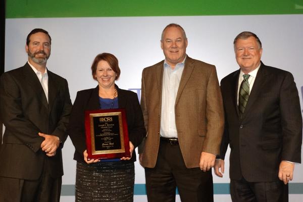 Susan Rich Farris, Director of Corporate Communications at Shaw Industries, was honored with the Joseph J. Smrekar Memorial Award. She is pictured (L-R) with David Jolly, Milliken President Jim McCallum and CRI President Joe Yarbrough.