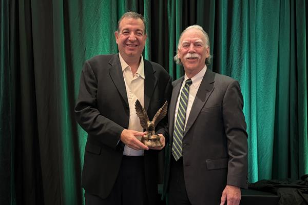 Dr. Bob Peoples presents the CARE Person Of The Year award to David Bender